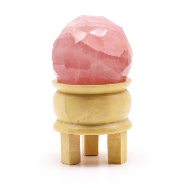Boule de quartz rose taillée à facettes sur son socle en bois