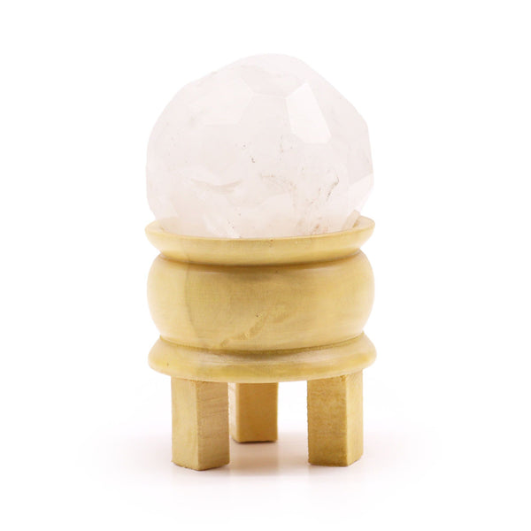 Boule de cristal de roche taillée à facettes sur son socle en bois